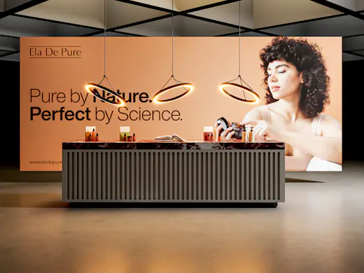 A branded exhibition counter with a printed backdrop